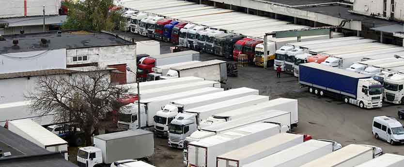 Parking lot full of semi trucks needing fleet maintenance