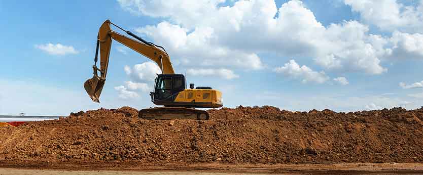 An excavator on a jobsite needing a repair